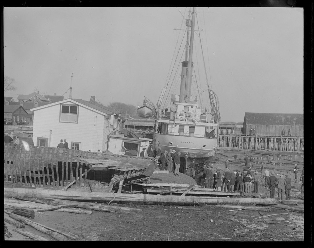 USS Merrill washed ashore in storm against pier at Provincetown, Mass