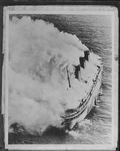 French liner SS Atlantique on fire off Guernsey, England