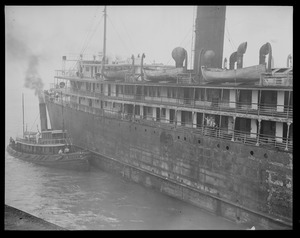 SS Fairfax being towed to Simpson's drydock in East Boston after fire in which 46 lives are lost. Tugboat 'Powow.'
