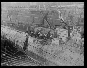 Sub S-51 in Brooklyn Navy Yard drydock. Shows breach where SS City of Rome rammed her.