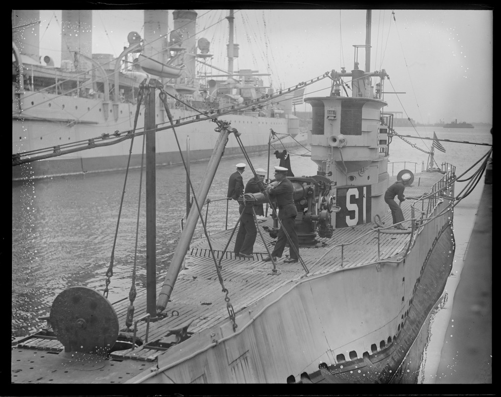 Officer and crewman on deck of sub S-1 converse over gun, at Navy Yard