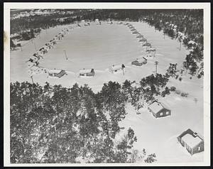Snowbound - An air view of the summer resort area at West Dennis on Cape Cod after the region's worst snow storm in a generation. Besides the unusual amount of sow, high winds piled up deep drifts.