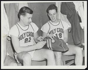 It's In The Bag' is the obvious description of this pose as Capt. Bobby Curran (left) and Andy Laska of Holy Cross talk about the coming college basketball season. The Crusaders are the defending N.C.A.A. champions and they hope to repeat their triumphs of a year ago. Both players, by the way, are homebreds, for Curran is a product of St. John's High of Worcester, while Laska is a graduate of Worcester North High