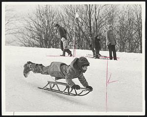 Parting Company - This youngster and sled part company as he flies over bump while sliding at Larz Anderson Park, Brookline