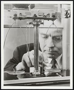 One-Hundred carats of the first man-made diamonds produced in the pilot plant of G. E.'s Carboloy Department, Detroit, are being weighed here. J. S. Gillespie, manager of Carboloy's diamond project, weighed the industrial diamonds which have been mounted in a special plaque presented to the Smithsonian Institution in Washington today.