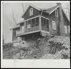 Can it be Saved?-Home movers began efforts to pull this $18,000 residence to safety before it is completely undermined by shifting earth in Cleveland, O. The landslide caused a million dollars damage to other property.