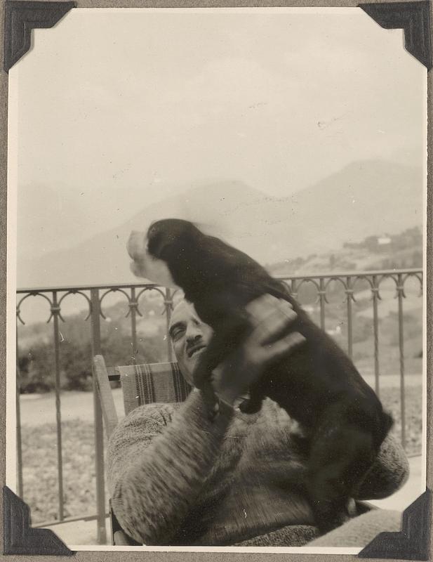 An unidentified man holding a Boston terrier