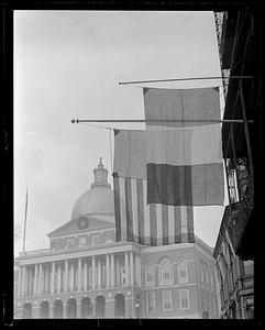 Flags hanging, Massachusetts State House in background
