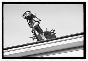 An elaborate device on roof, possibly a weather vane