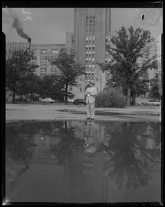 Edward F. Cassell, appraiser, standing in front of the Sears building