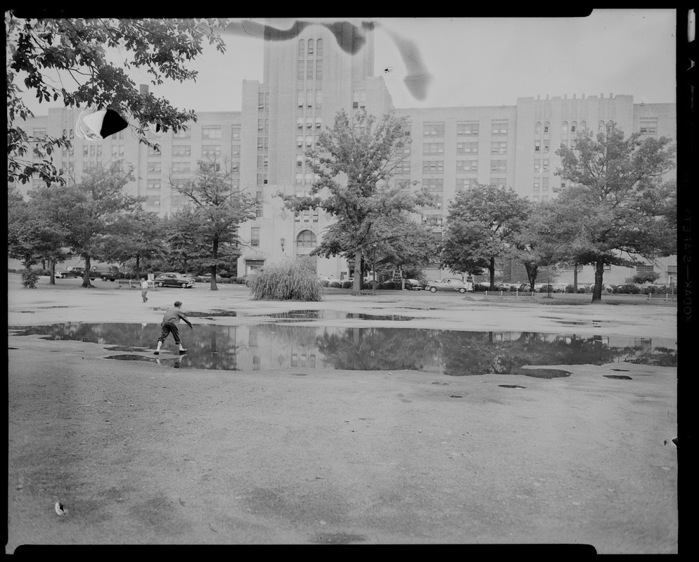 View of Sears building with a young man in a water puddle