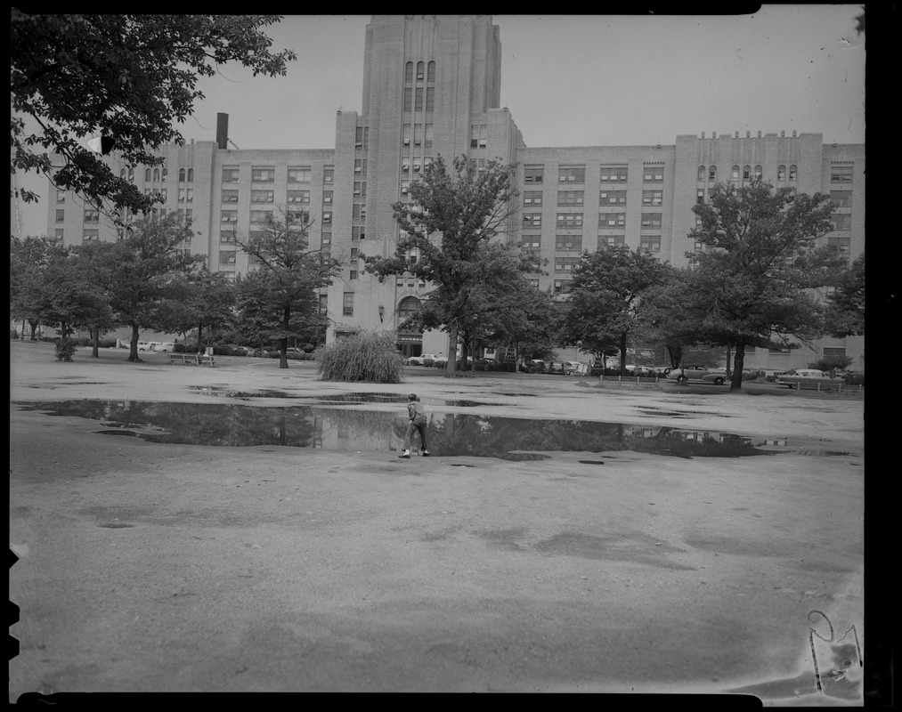 View of Sears building with a young man in a water puddle