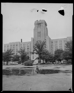 View of Sears building with a young man in a water puddle