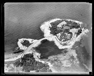 An house on a small island, attached by a bridge