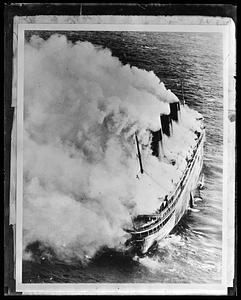 French liner SS Atlantique on fire off Guernsey, England