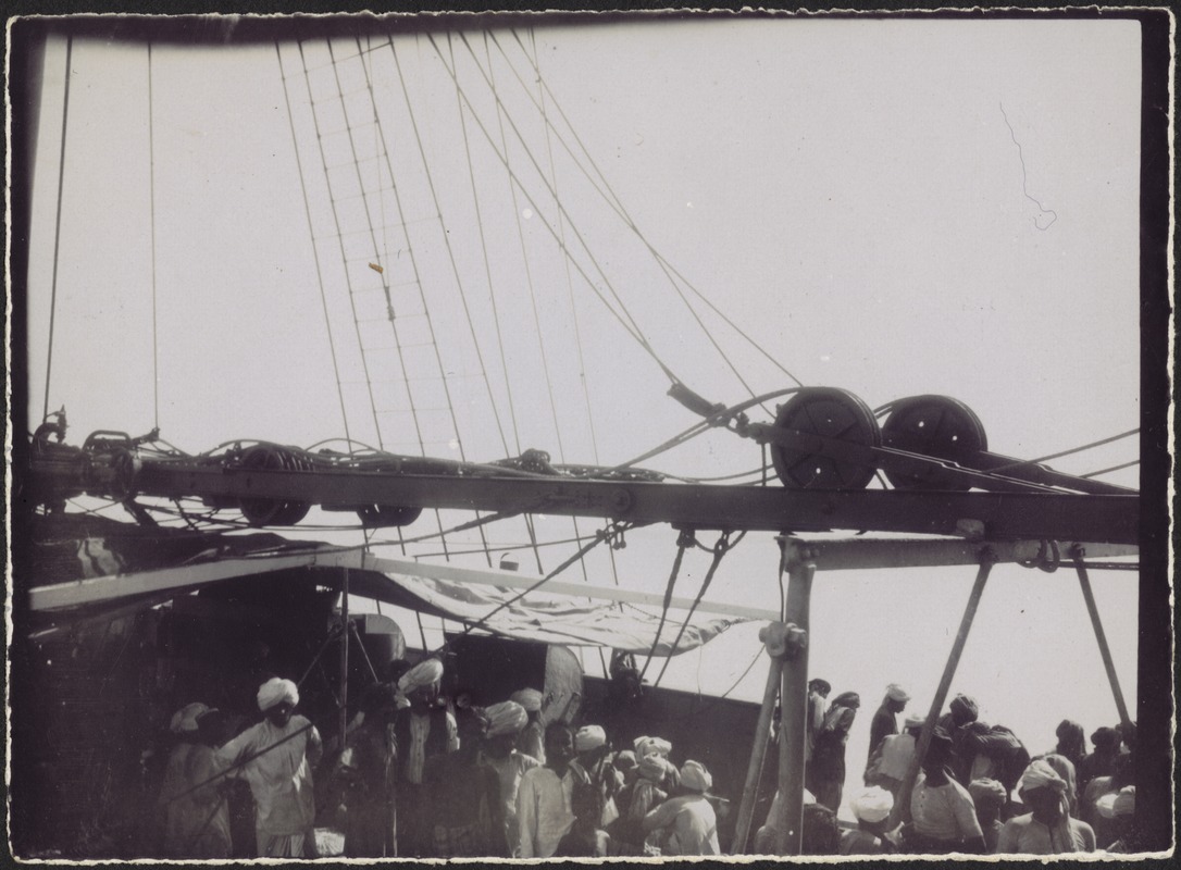 Men wearing turbans on deck of sailing vessel