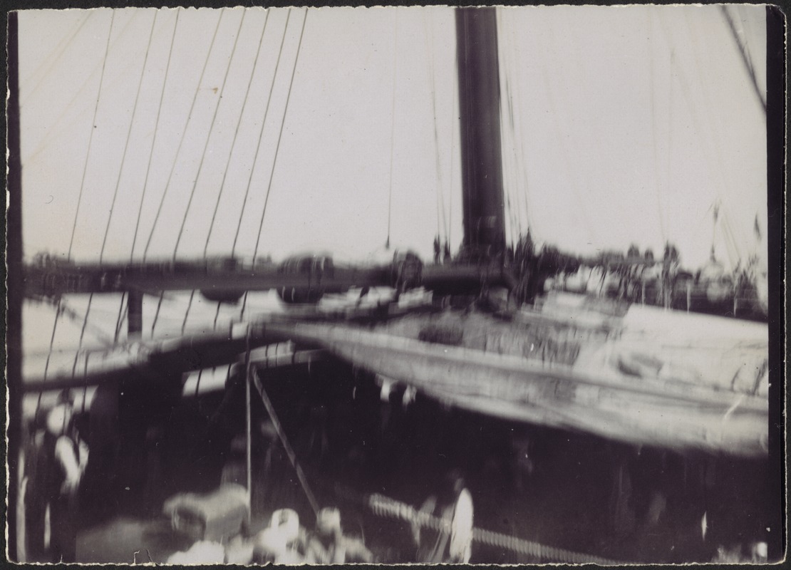 Blurry photo of men wearing turbans on deck of sailing vessel