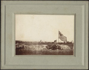 Sandbagged trench with American flag flying