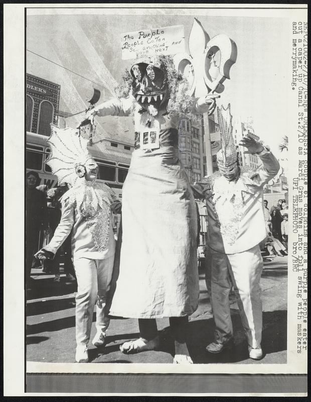 A couple of dolphins and a purple people eater cut a caper up Canal St. 2/10 as Mardi Gras moves into full swing with maskers and merrymaking.