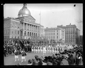 Parade of nurses marching down Beacon St., Boston State House in background