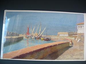Boats in harbor, viewed behind seawall in the foreground