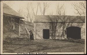 Miss Mary Baker with broom in front of her house