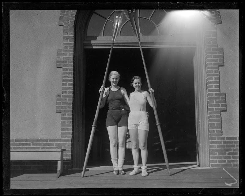 Two women holding oars