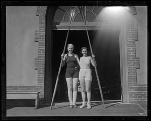 Two women holding oars