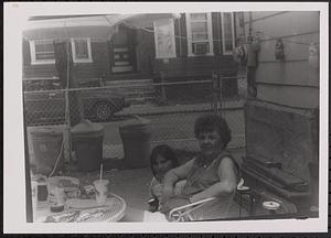 A young woman and an older woman sitting at a table outside