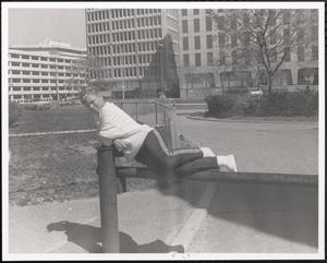 Girl balancing on parking barrier