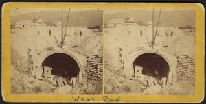 West end of tunnel showing brick lining, some debris & people