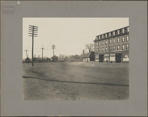 Photograph of the end of the railroad platform looking south, railroad shanty on the left and a large building on the right at South Braintree