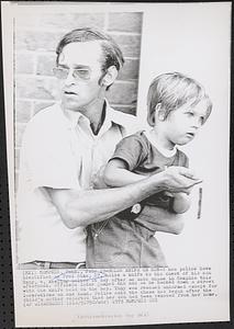 Holds knife on son