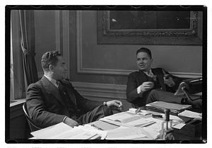 Two men seated at a desk