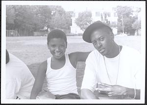 Boy and young man sitting and smiling