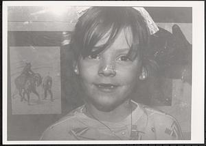 Closeup of a girl with a toothless grin