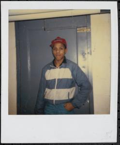 Young man posing in front of a door