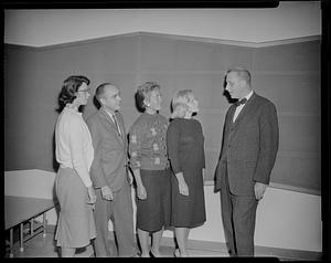 Group talking to man with bow tie