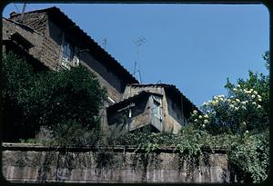 Building visible above wall, Rome, Italy
