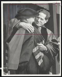 Abram Sachar, retiring president of Brandeis, embraced by successor Morris Abram during installation ceremonies.