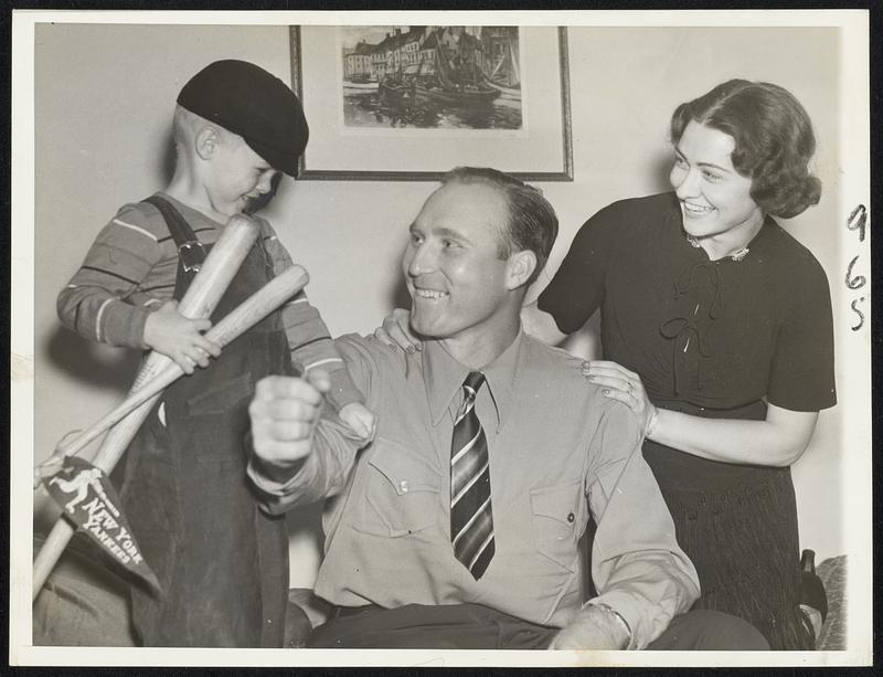 "Atta Boy, Daddy". Charley Ruffing had this welcome from his wife and junior when he came home from the Yankee Stadium Oct. 7 with an 8-1 victory over the Giants under his belt. Pitcher Ruffing held the Giants to seven hits in this second World Series game, got two hits himself to drive in three runs and fanned eight batsmen. He managed to slip out and buy junior a souvenir bat though.