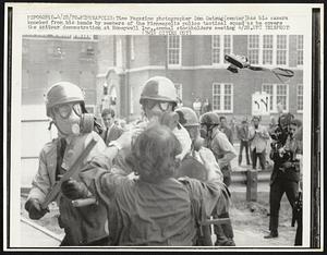 Time Magazine photographer Don Getsug (center) has his camera knocked from his hands by members of the Minneapolis police tactical squad as he covers the antiwar demonstration at Honeywell Inc., annual stockholder meeting 4/28.