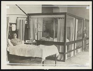 Glass Case Filled With Oxygen Newest Medical Device. A sealed glass room has been installed at Guy's. London's most famous old hospital, for the treatment of patients with oxygen. The room is kept filled with air containing double the amount of oxygen present in normal atmosphere. Special arrangements also providing for absolute purity of the air within the "show case". Note lock on door to prevent accidental opening and contamination.