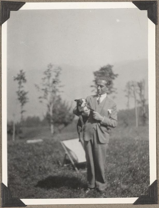 An unidentified man holding a Boston terrier