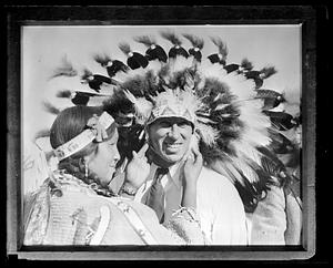 An unidentified man wearing a headdress
