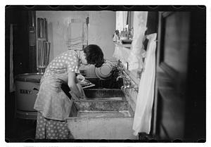 Woman doing laundry at a sink