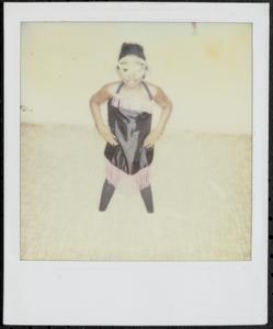 Girl posing in black and pink costume