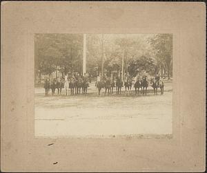 15 men on horseback on Main Street