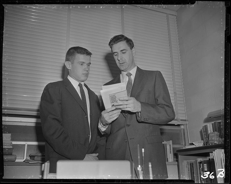 Man showing student a book