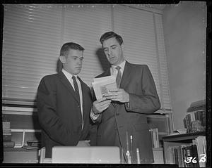 Man showing student a book